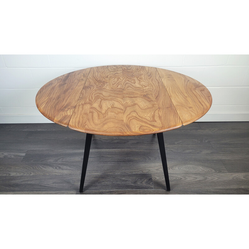 Vintage round dining table with black leg by Ercol, 1960s