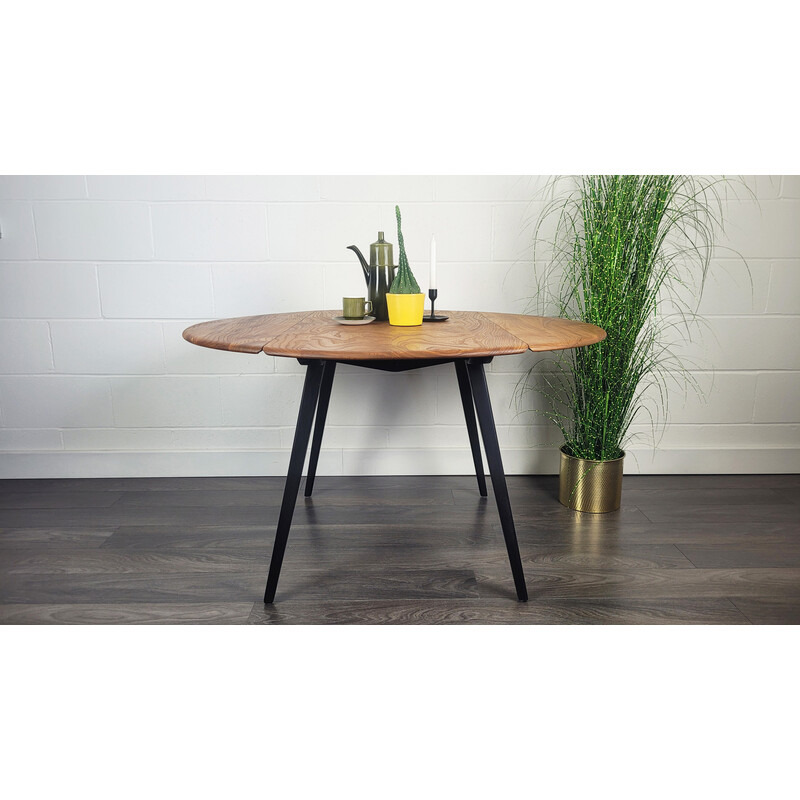 Vintage round dining table with black leg by Ercol, 1960s