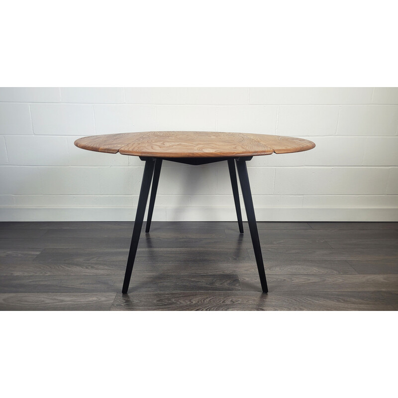 Vintage round dining table with black leg by Ercol, 1960s