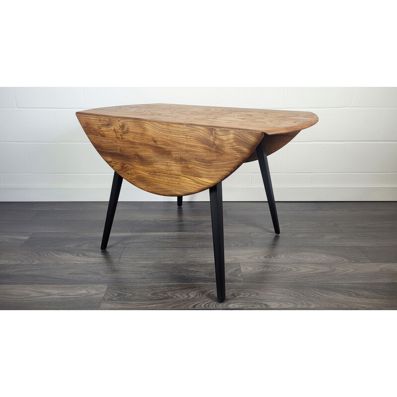Vintage round dining table with black leg by Ercol, 1960s