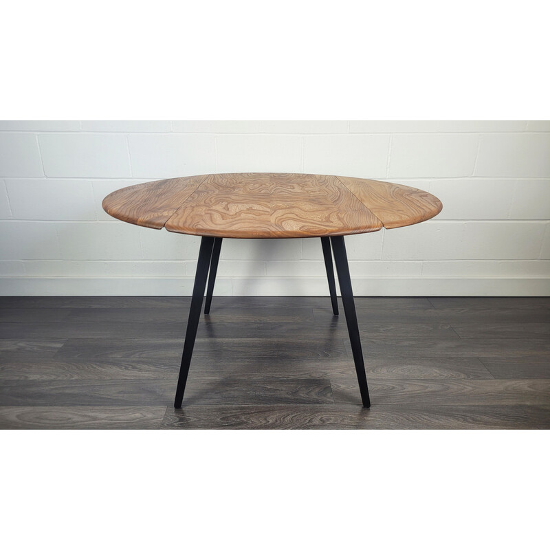 Vintage round dining table with black leg by Ercol, 1960s