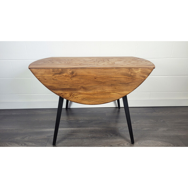 Vintage round dining table with black leg by Ercol, 1960s
