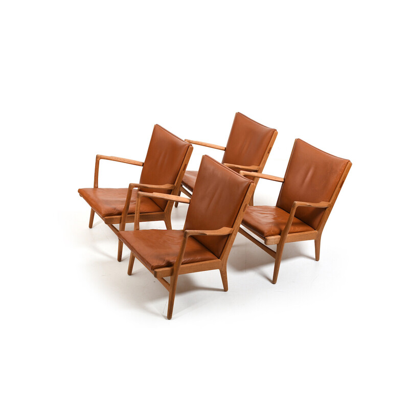 Set of 4 vintage oak and cognac leather armchairs by Hans J. Wegner for AP Stolen, Denmark 1951