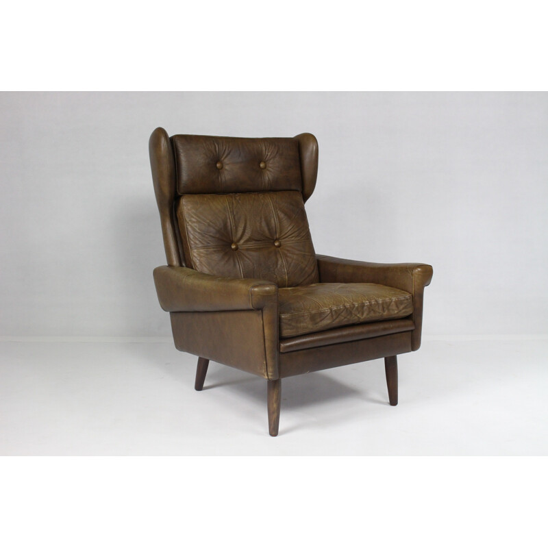 Modern wingback easy chair in brown leather - 1970s