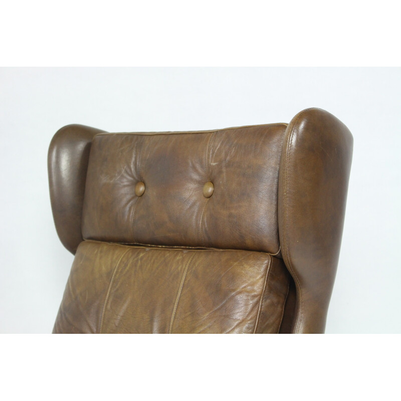 Modern wingback easy chair in brown leather - 1970s