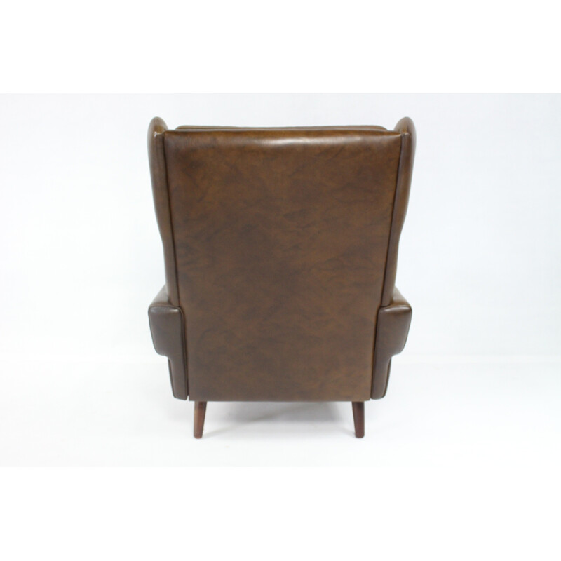Modern wingback easy chair in brown leather - 1970s
