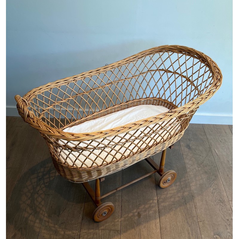 Vintage rattan cradle on wheels, France 1950