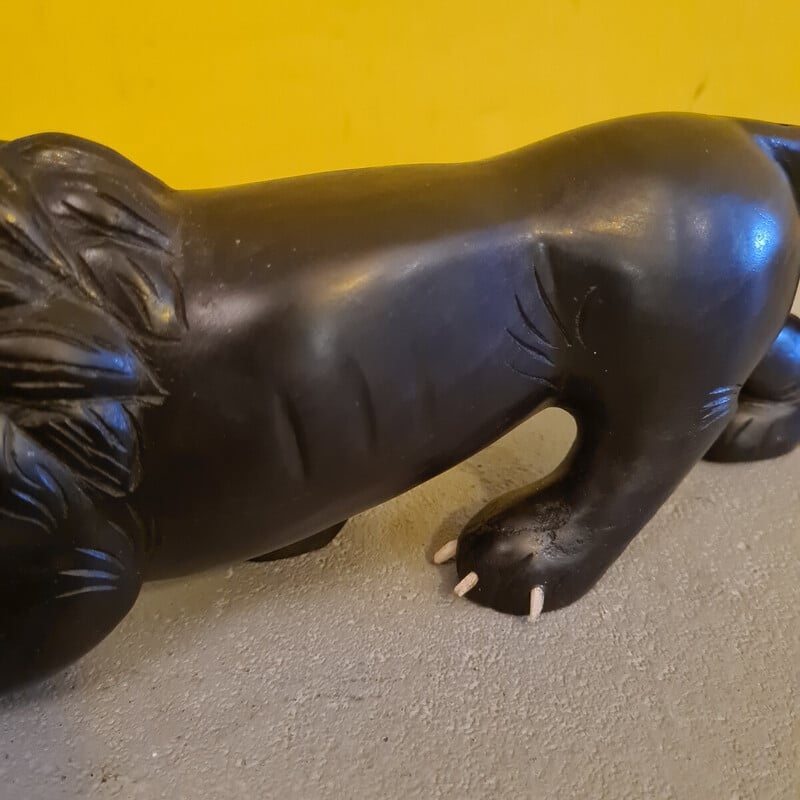 Vintage ebony sculpture depicting a menacing lion, 1940