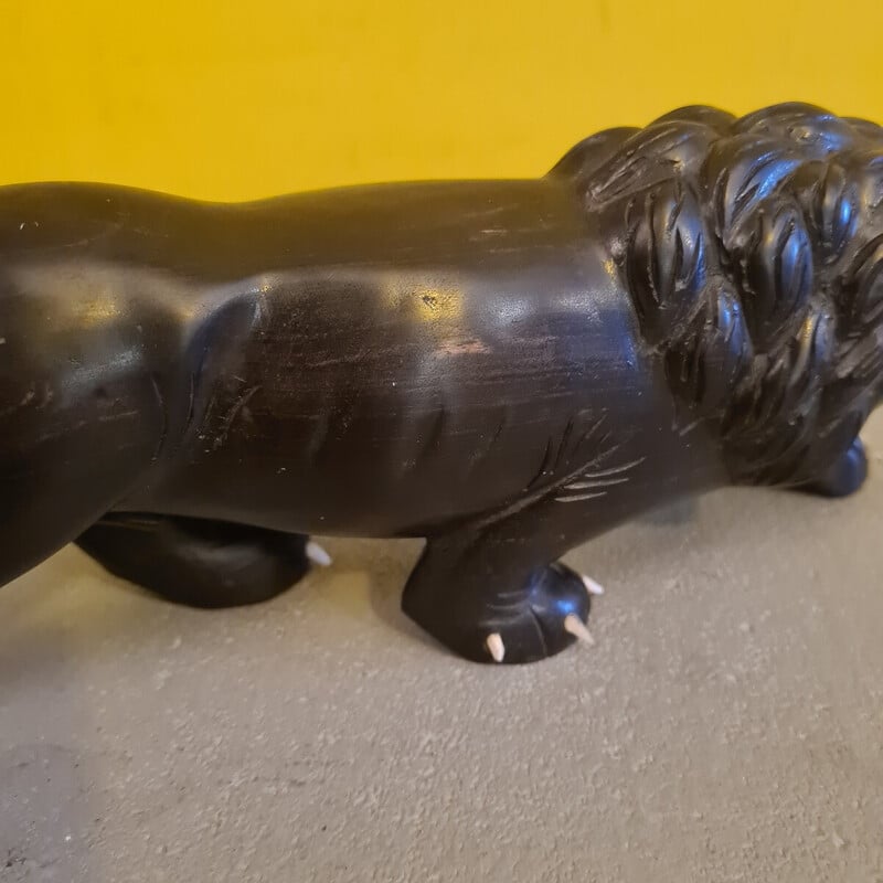 Vintage ebony sculpture depicting a menacing lion, 1940