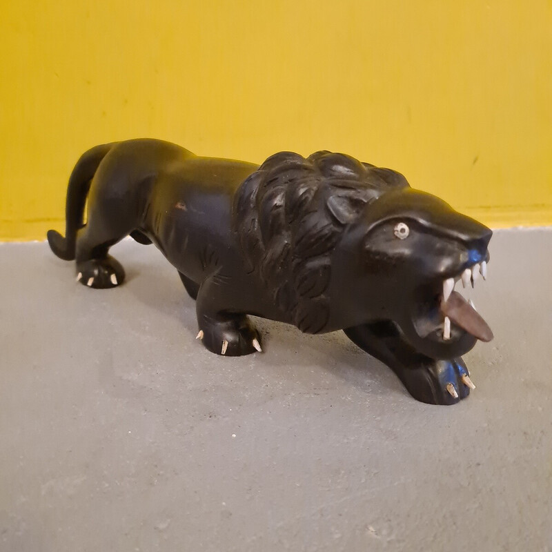 Vintage ebony sculpture depicting a menacing lion, 1940