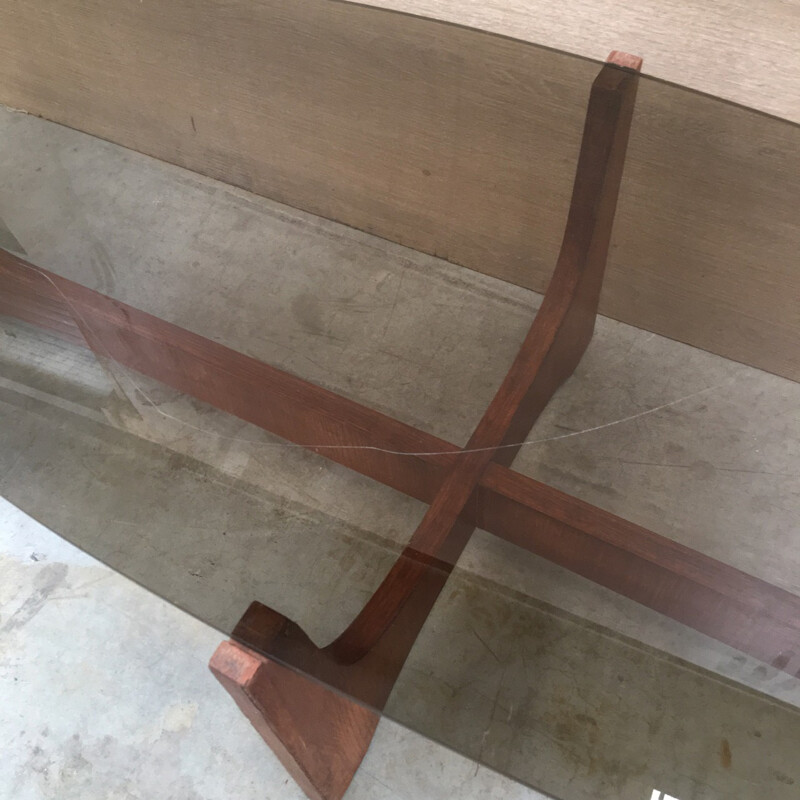 Oval coffee table with a teak base and a smoked glass top by Hugues Poignant - 1960s