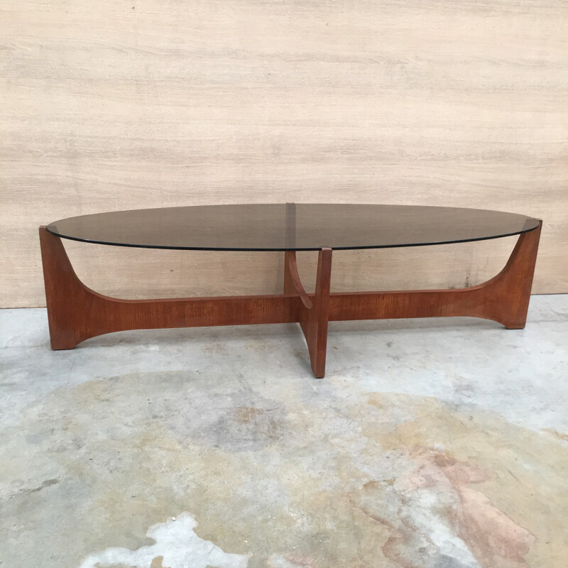 Oval coffee table with a teak base and a smoked glass top by Hugues Poignant - 1960s