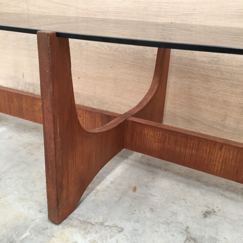 Oval coffee table with a teak base and a smoked glass top by Hugues Poignant - 1960s