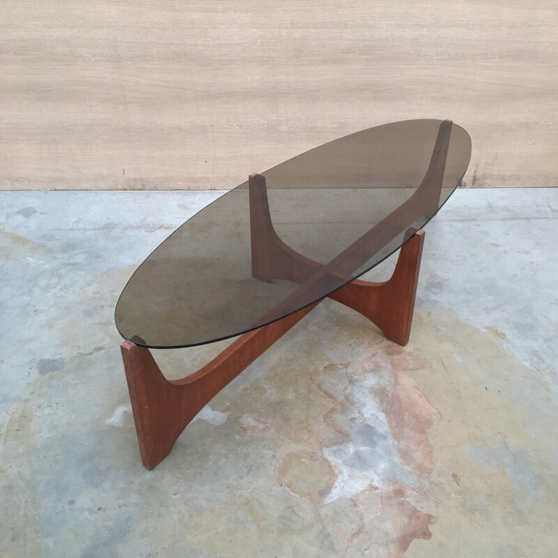 Oval coffee table with a teak base and a smoked glass top by Hugues Poignant - 1960s