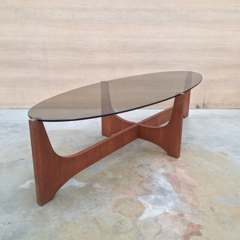 Oval coffee table with a teak base and a smoked glass top by Hugues Poignant - 1960s