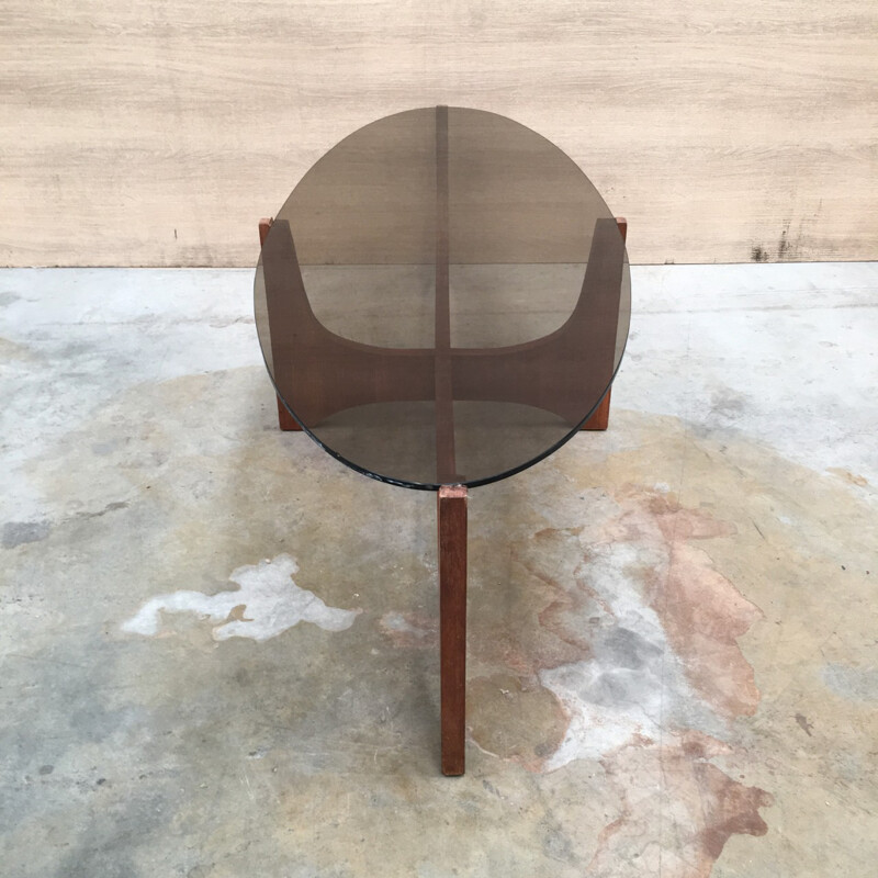 Oval coffee table with a teak base and a smoked glass top by Hugues Poignant - 1960s