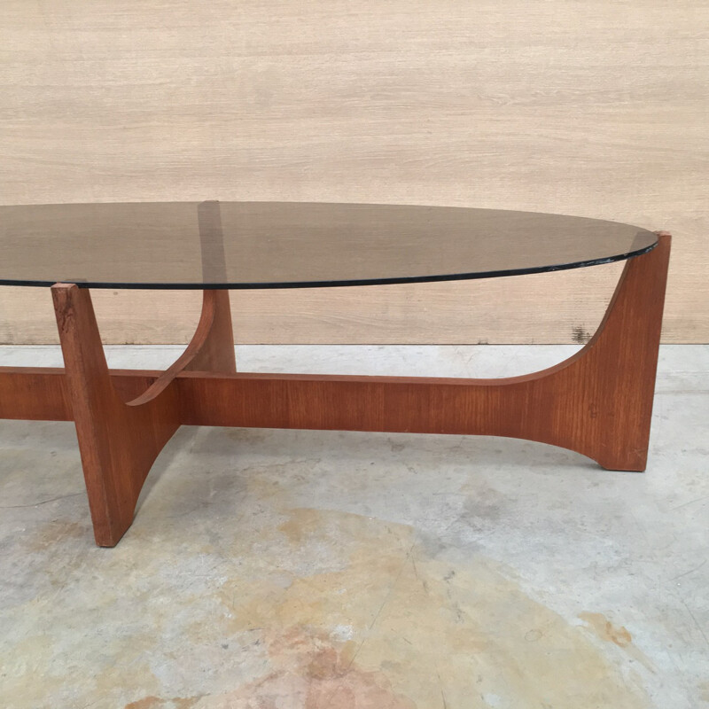 Oval coffee table with a teak base and a smoked glass top by Hugues Poignant - 1960s