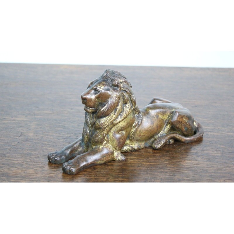 Vintage lying lion in gold cast iron