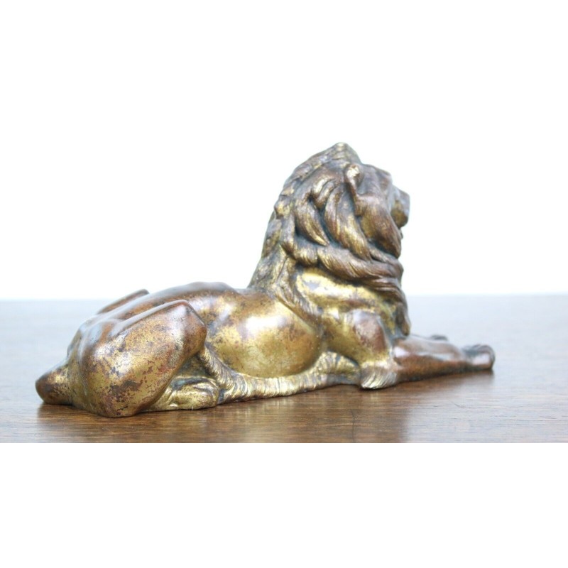 Vintage lying lion in gold cast iron