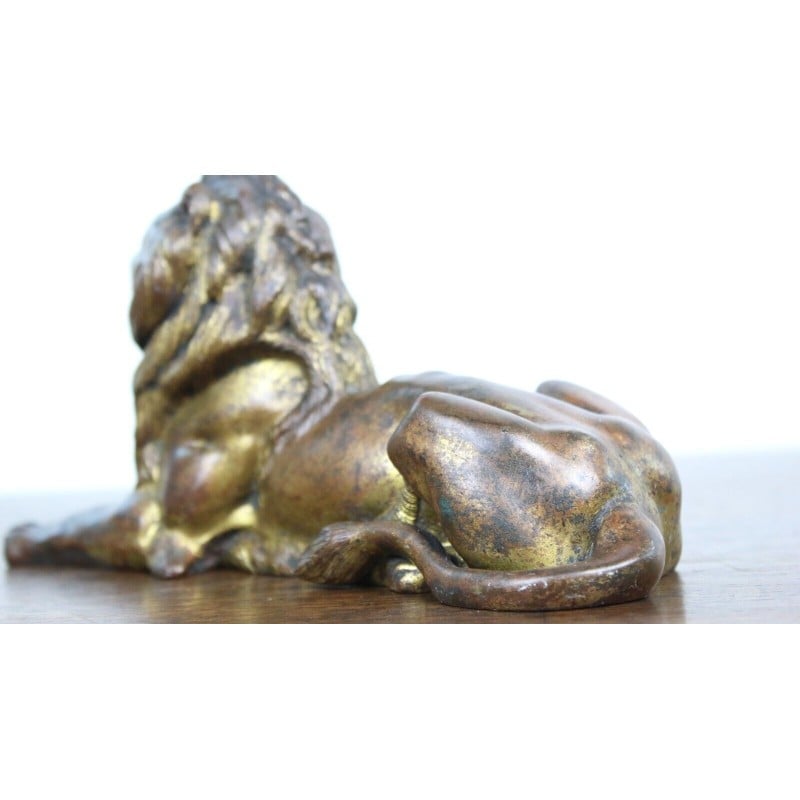 Vintage lying lion in gold cast iron