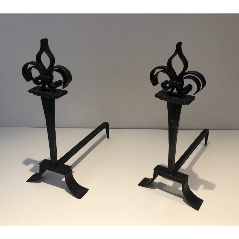 Pair of vintage wrought iron andirons topped with fleur-de-lys, France 1950