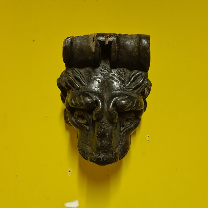 Escultura vintage em madeira preta polida representando uma cabeça de leão