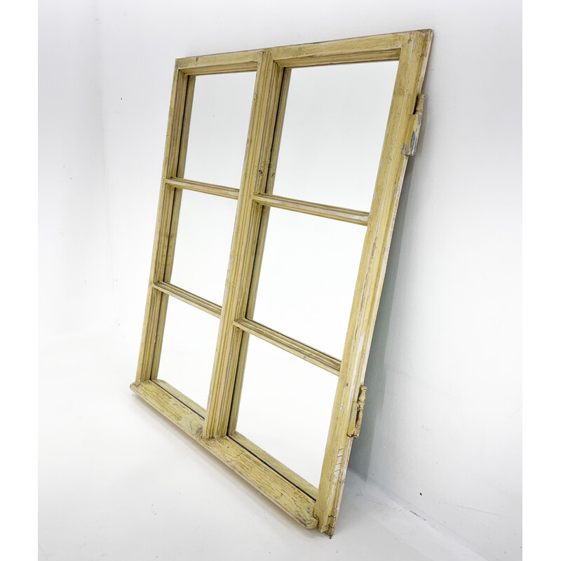 Vintage wooden window transformed into a mirror