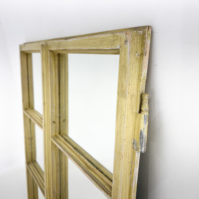 Ein altes Holzfenster, das in einen Spiegel verwandelt wurde