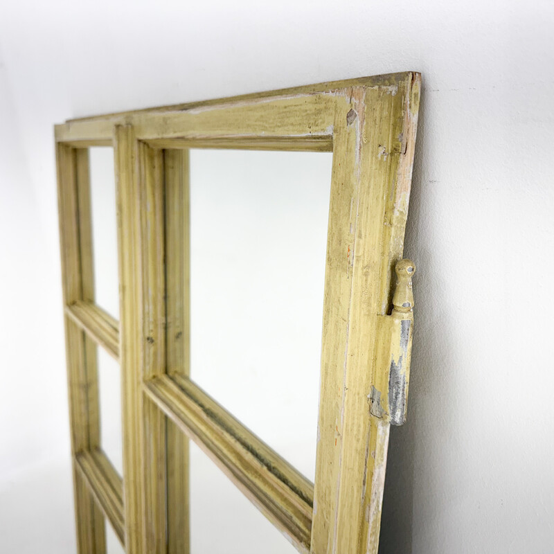 Vintage wooden window transformed into a mirror