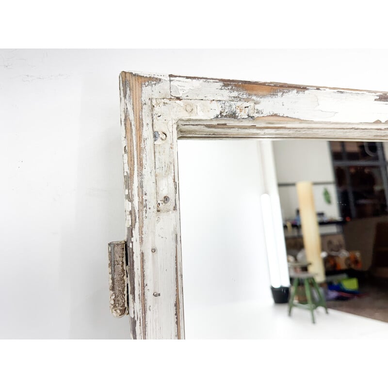 Vintage wooden window transformed into a mirror