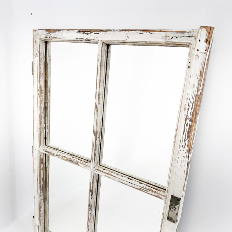 Vintage wooden window transformed into a mirror