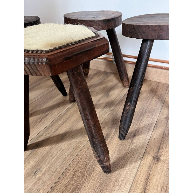 Set of 4 vintage tripod stools covered in cowhide