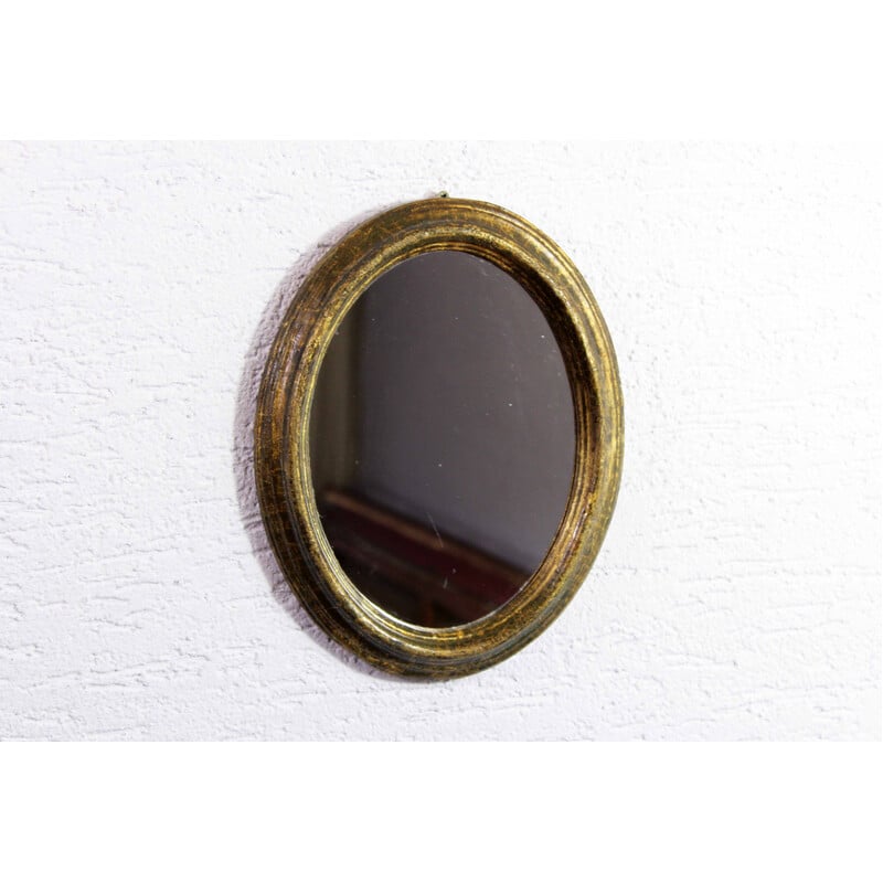 Vintage oval mirror in gilded resin frame with gold leaf, 1970