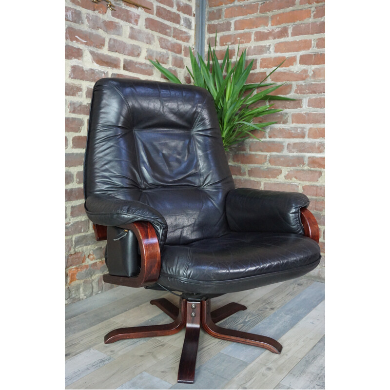 Leather tilting armchair with ottoman - 1970s