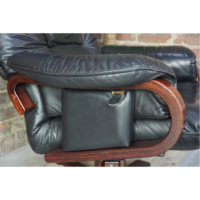 Leather tilting armchair with ottoman - 1970s