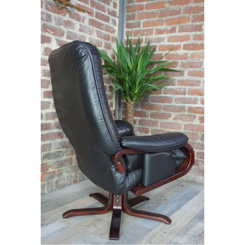 Leather tilting armchair with ottoman - 1970s