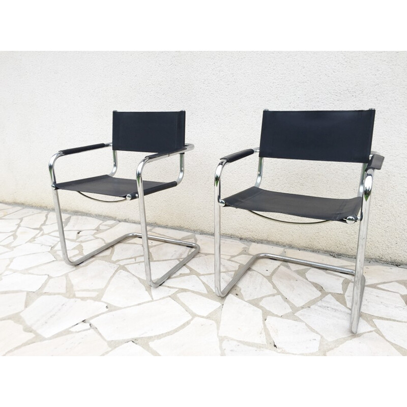 A pair of vintage armchairs made of leatherette and chrome - 1970s