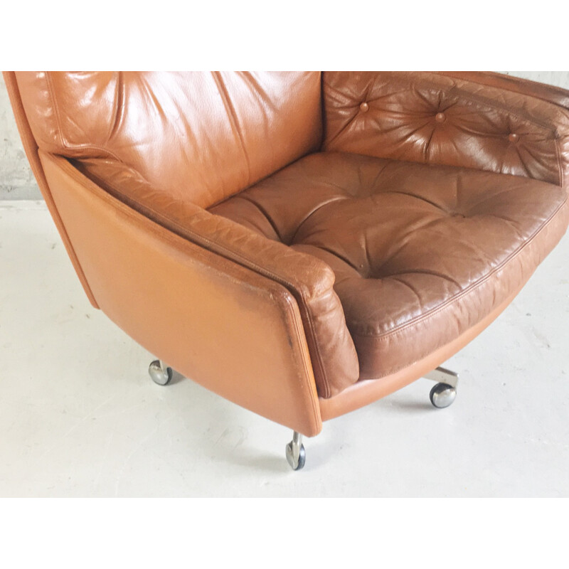 Vintage Danish brown leather armchair on swivel base with castors - 1970s