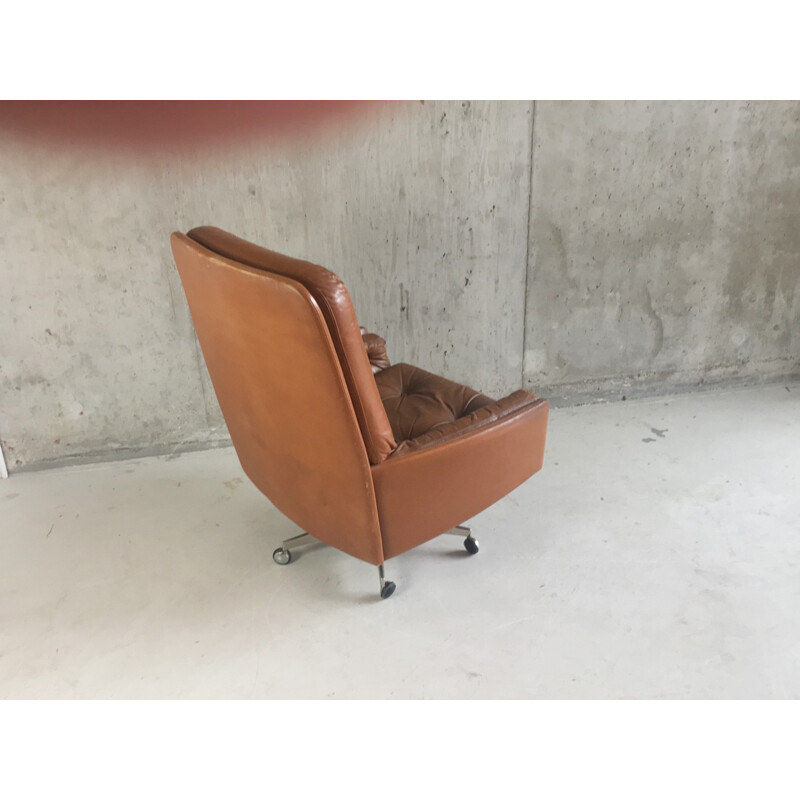 Vintage Danish brown leather armchair on swivel base with castors - 1970s