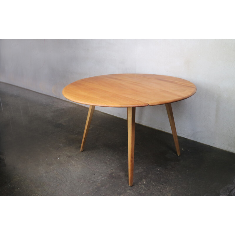 Vintage beech & elm circular drop leaf dining table by Ercol - 1950s