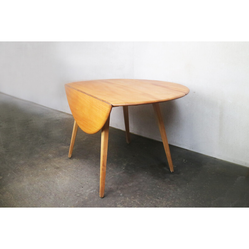 Vintage beech & elm circular drop leaf dining table by Ercol - 1950s