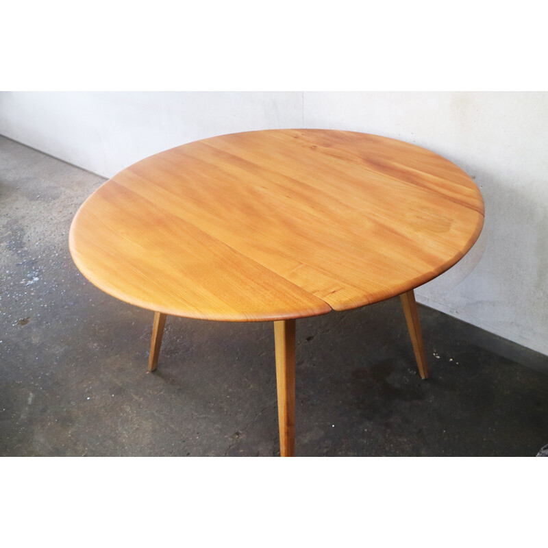 Vintage beech & elm circular drop leaf dining table by Ercol - 1950s