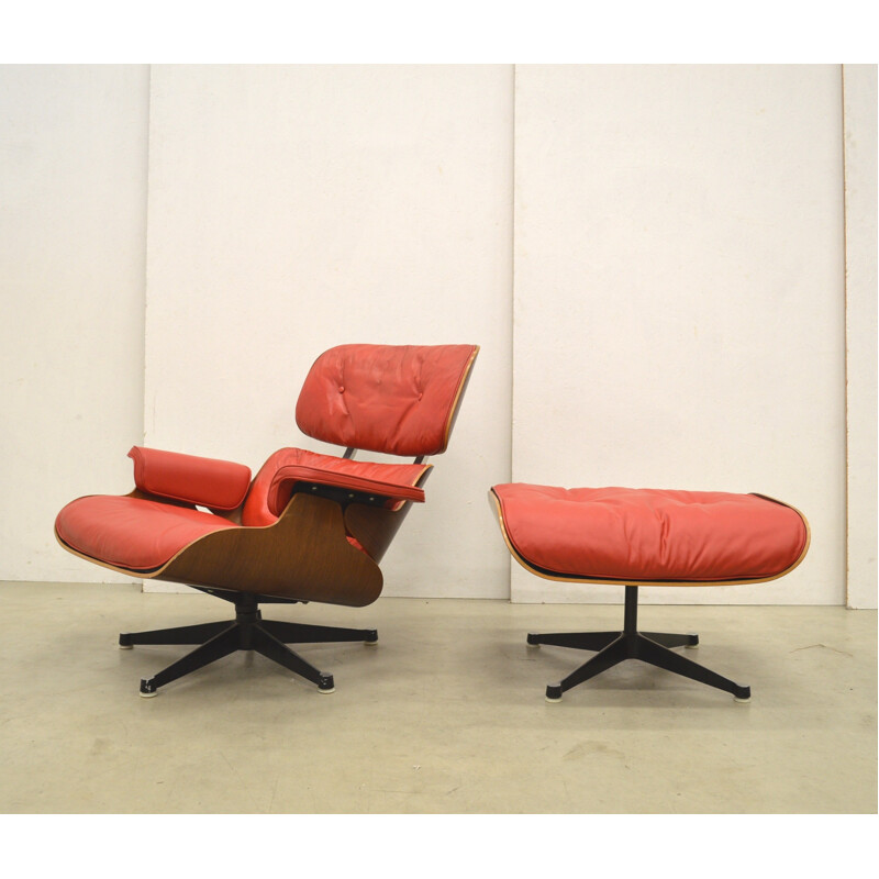 Vintage lounge chair and ottoman in read leather by Herman Miller for Charles & Ray Eames - 1950s