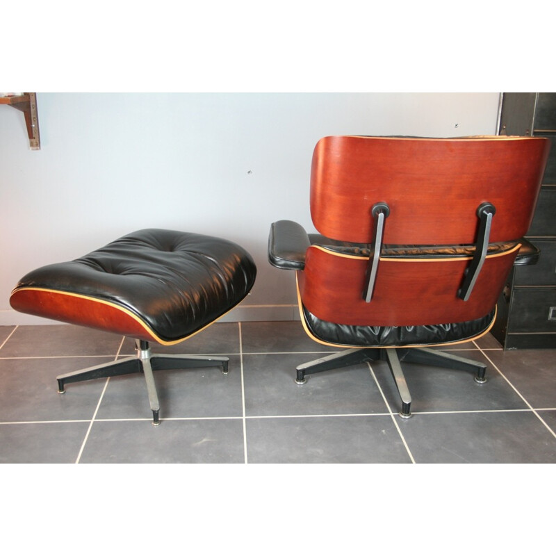 Vintage black lounge chair and ottoman in cherrywood by Eames for Herman Miller - 2000s