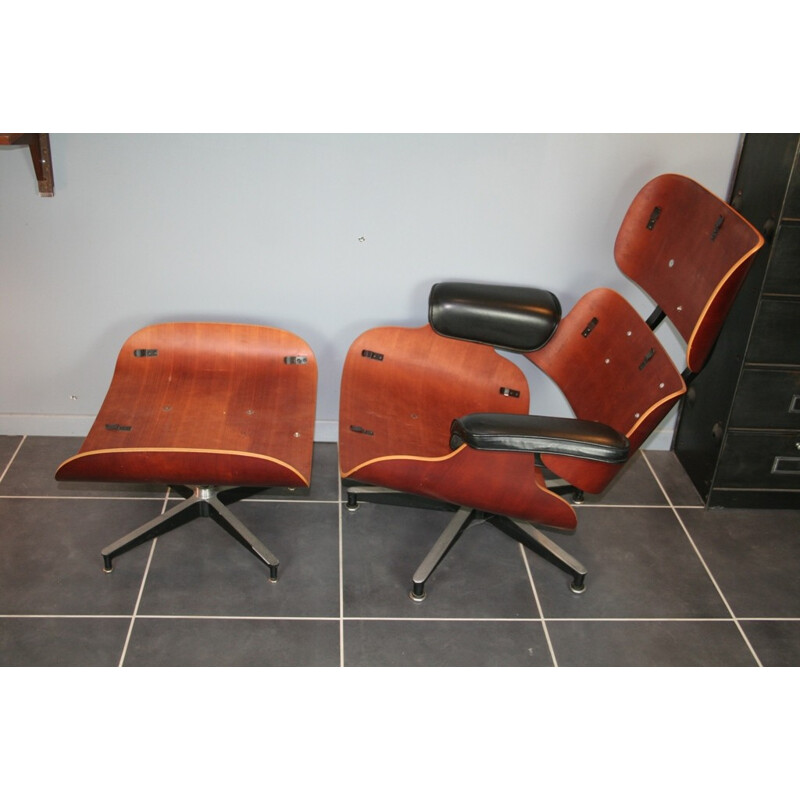 Vintage black lounge chair and ottoman in cherrywood by Eames for Herman Miller - 2000s