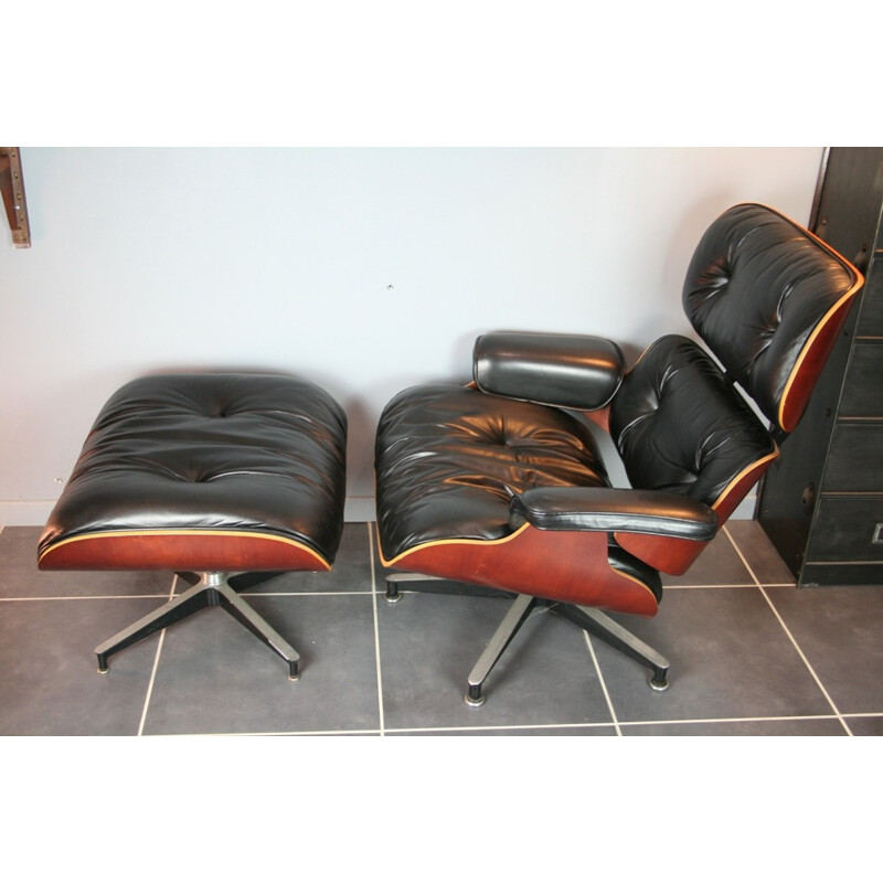 Vintage black lounge chair and ottoman in cherrywood by Eames for Herman Miller - 2000s