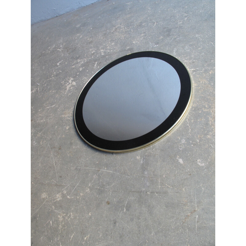 Miroir vintage rond avec cadre noir et bord doré - 1960