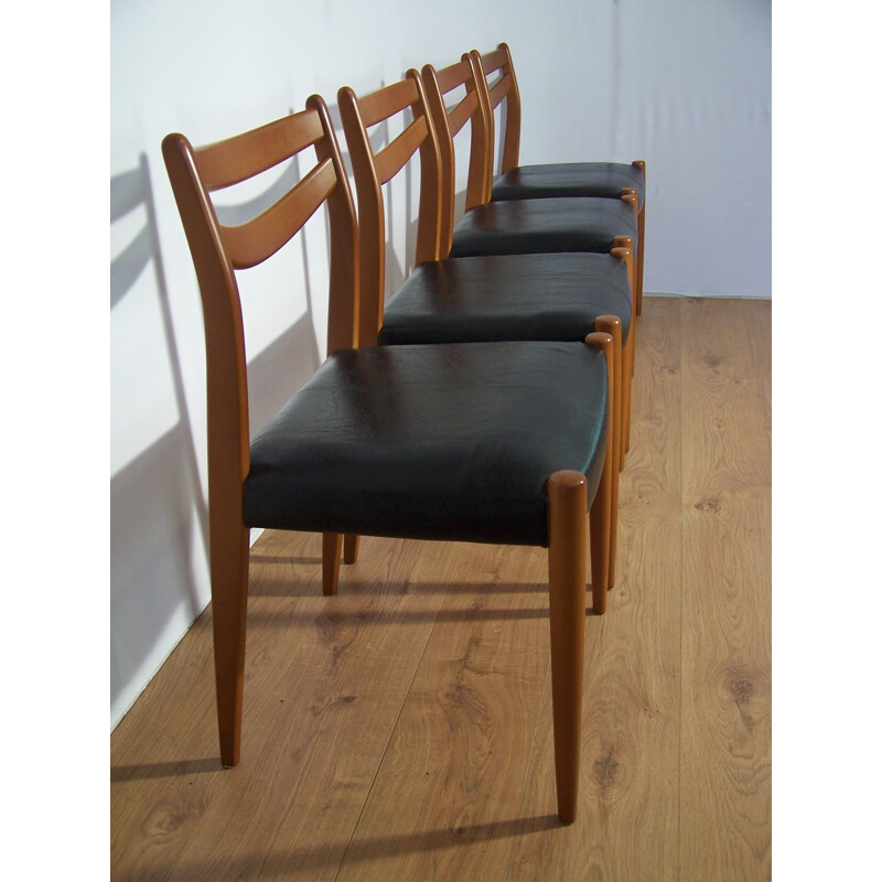 Suite de 4 chaises en bois et simili cuir noir 1960