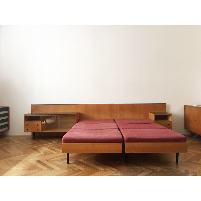 Vintage twin beds with night stands by Mojmir Pozar