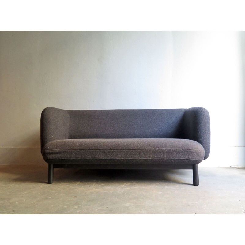Vintage grey sofa in a wooden base